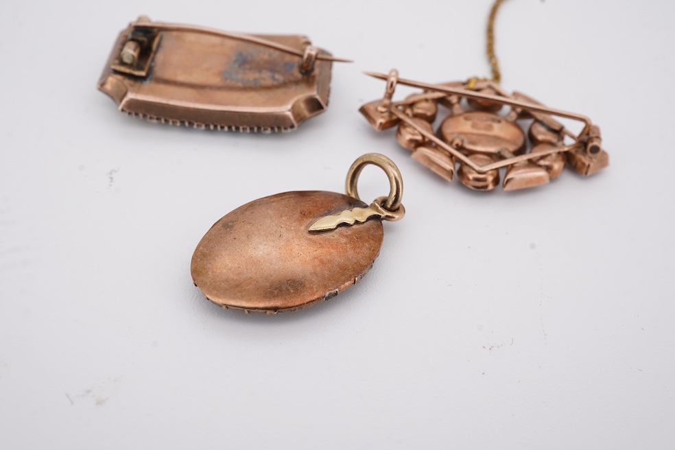 Three assorted Victorian brooches including a 9ct and garnet cluster by Murrle Bennett & Co, 27mm, a micro mosaic bar brooch and a yellow metal and split pearl mourning brooch, together with a gem set oval pendant. Condi